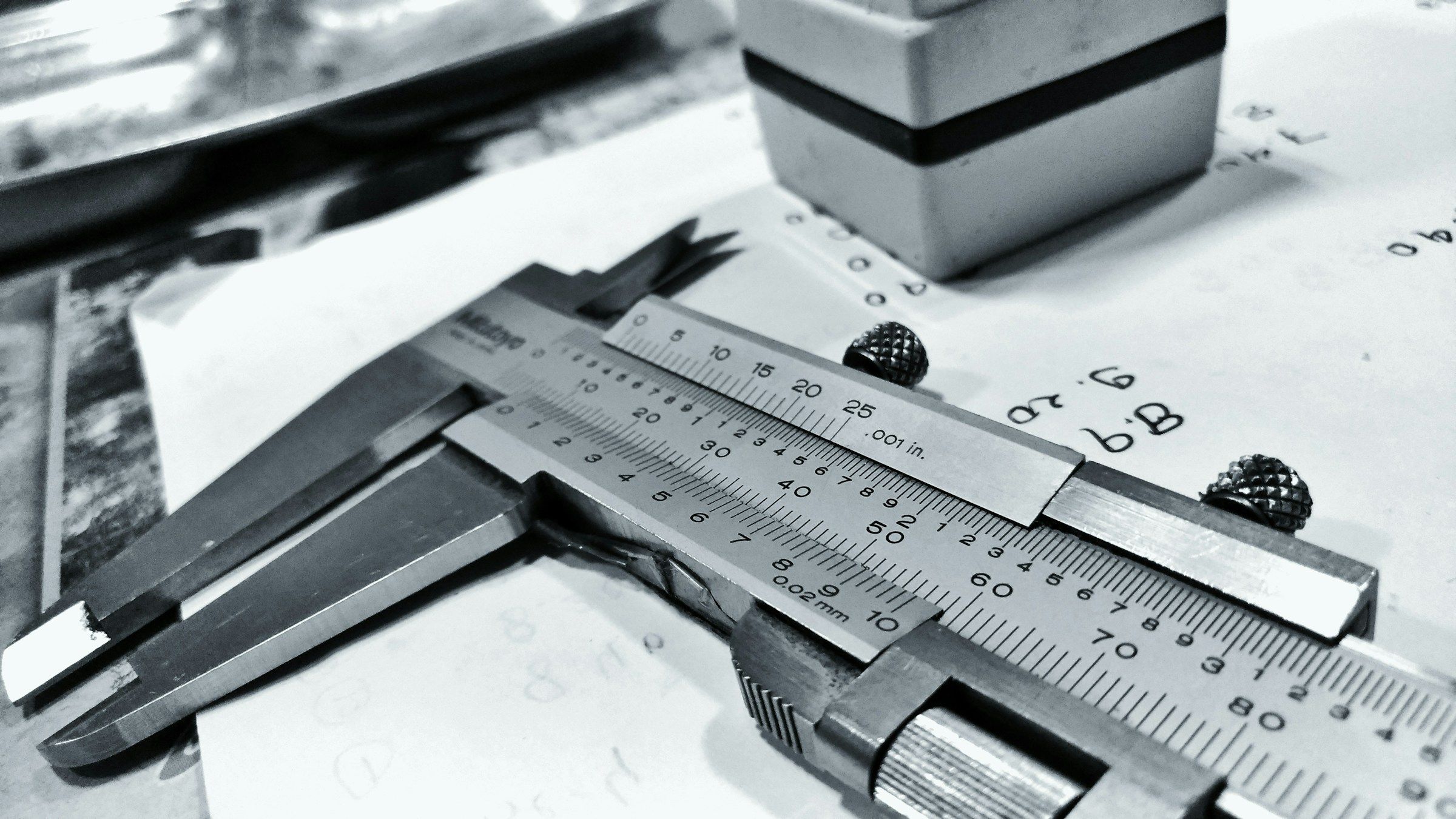 Precision calipers on a technical drawing